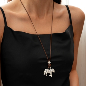 Detail of silver zebra pendant on brown leather cord with wood bead on a model