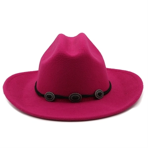 Detail of fuchsia wide brim wool fedora with black rope band and vintage silver conchos