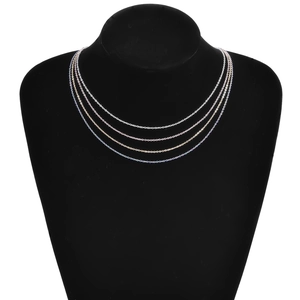 Layered 18k gold plated stainless steel lip chains displayed on a black bust