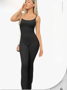 Detail of seamless ribbed texture and slim fit on a black yoga jumpsuit with straps