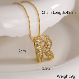 Macro detail of gold R letter pendant necklace with cubic zirconia and 45cm chain dimensions