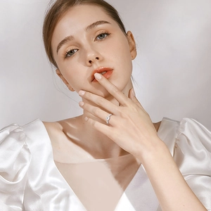 Classic Moissanite diamond ring in S925 sterling silver worn by a model in studio light