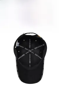 Detailed interior of black baseball cap showing reinforced seams and breathable eyelets