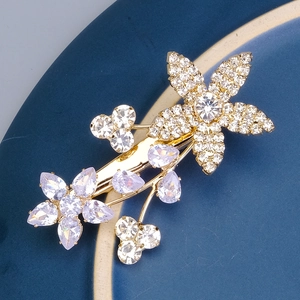Macro shot of gold floral hair clip featuring sparkling crystals and zircon petals