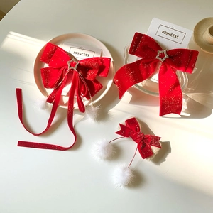 Red velvet bow hair clips set with white pom poms and stars for festive girls' styling