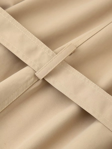 Detailed macro view showing khaki twill cotton fabric texture and double-stitched belt loop