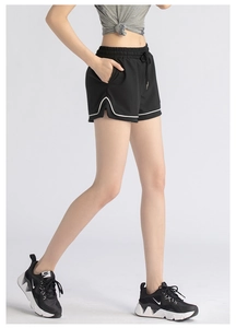 Detail view of black running shorts with elastic drawstring waist and side slit design
