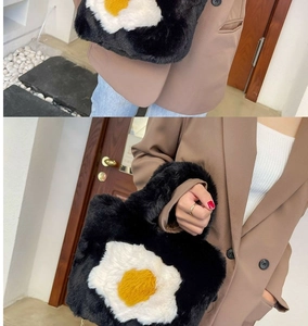 Detailed close-up of a black plush tote bag featuring a cute poached egg graphic design