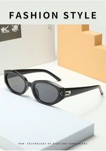 Detailed view of irregular cat eye sunglasses with silver U-shaped metal hinge accents