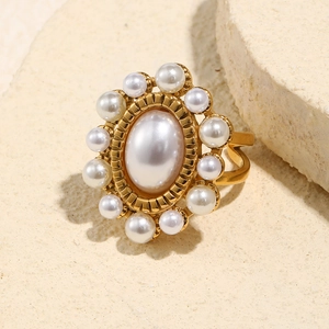 Close-up of 18K gold-plated adjustable ring featuring multiple faux pearls on stone base