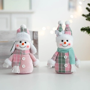 Detailed close-up of handmade knit snowman dolls with pink and green plaid scarves