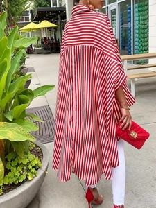 Elegant oversized red and white striped long sleeve shirt with asymmetrical hem design