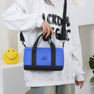 Blue nylon pillow bag with black straps and JLP logo, shown as a stylish crossbody bag