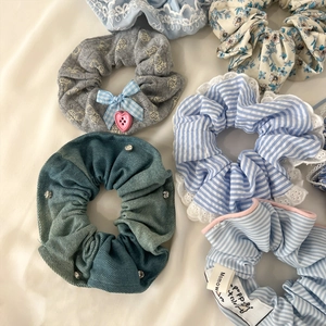 Detail of assorted lace and denim hair scrunchies with elegant rhinestone ornaments