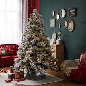 Pre-lit flocked Christmas tree with warm lights and woven base in vintage interior setting