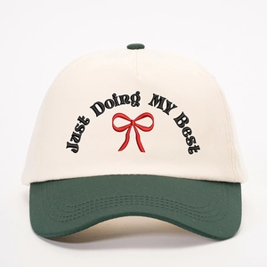 Two-tone baseball cap in off-white and dark green with Just Doing My Best embroidery