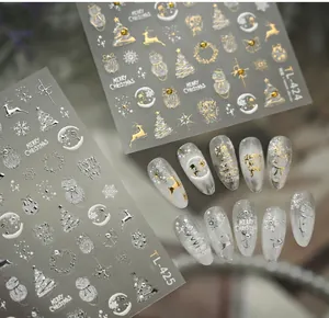 Detail of Christmas nail stickers with gold and silver reindeer, snowman and tree motifs