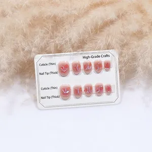 Short pink press-on nails with shimmering shell fragments on a white display card