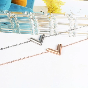 Polished titanium steel V-letter bracelets in silver and rose gold finishes