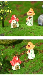 Miniature red and orange resin mushroom houses on green moss for micro landscape