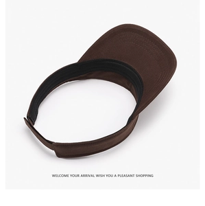 Detail of coffee brown sun visor showing canvas fabric texture and internal sweatband