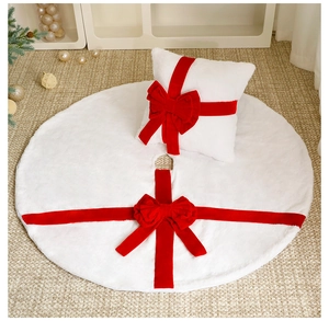 White plush Christmas tree skirt and pillow set with red velvet bows and ribbons