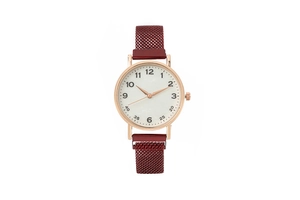 Detail view of stylish ladies watch with rose gold case and red Milanese mesh band