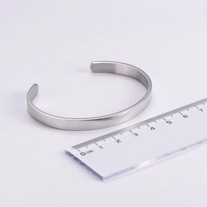Detailed view of a 6mm polished stainless steel C-shaped cuff bracelet with a silver finish