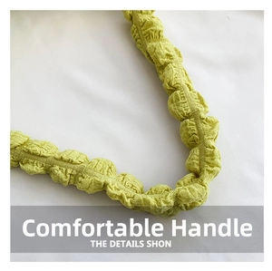 Close-up of comfortable handle showing textured ruched fabric in light green color
