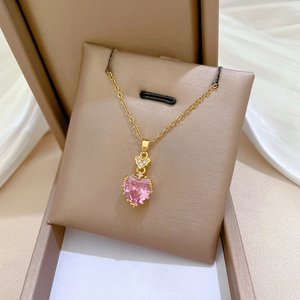 Close-up of pink heart zircon pendant necklace nestled in a luxury jewelry gift box