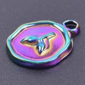 Detail shot of rainbow finish mermaid tail pendant on a matte black background