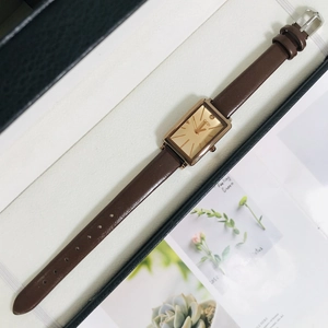 Macro shot of rectangular quartz watch with coffee leather strap and rose gold metal case