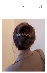 French twist hairstyle featuring a tortoiseshell resin hair clip on a model