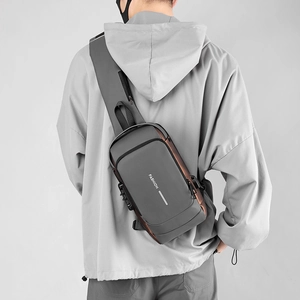 Detail view of water-resistant gray chest bag with anti-theft lock on male model