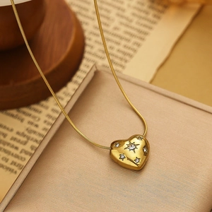 Golden heart pendant necklace with zircon stones on a refined snake chain link