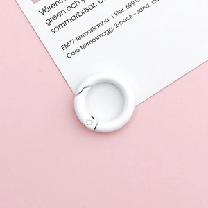 Detailed view of white painted 20mm round spring ring buckle on pink background