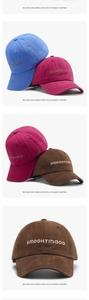 Detail of premium cotton baseball caps showing 3D letter embroidery and fine twill texture