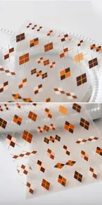 Detail of argyle pattern nail stickers in brown and gold for autumn manicure