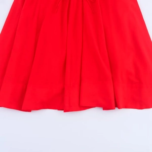 Close-up detail of red fabric pleats and drape on a midi camisole dress for women