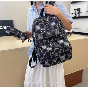 Detail of black plaid school backpack and pencil case set with cute rabbit doodle print