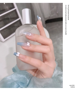 Blue and white gradient nail charms with 3D bows and stars on long coffin fake nails