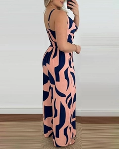 Detail of pink and navy geometric print jumpsuit with belted waist and sleeveless design