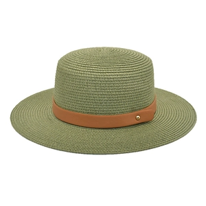 Detail of sage green straw hat with fine weave, brown leather band and golden metal stud