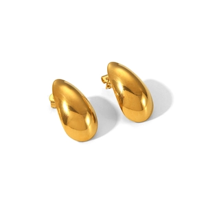 Close-up of golden teardrop stud earrings with polished mirror finish and butterfly backs