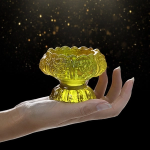 Translucent yellow lotus candle holder with embossed patterns and waisted pedestal base