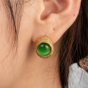 French vintage gold-plated C-shape earrings with emerald green zircon on model