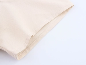 Close-up of the beige linen blend fabric texture and professional stitching on the sleeve