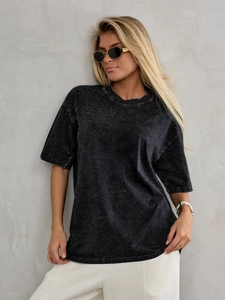 Detail of vintage washed black cotton T-shirt showing distressed texture and oversized fit