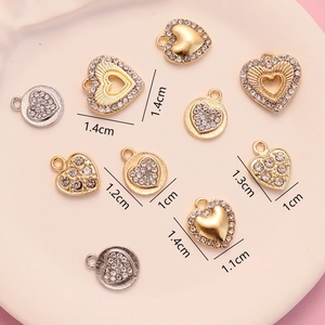 Macro shot of gold and silver heart-shaped pendants with rhinestones in various sizes