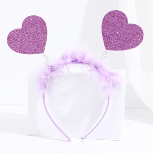 Close-up of a purple glitter heart headband with feather trim and spring details